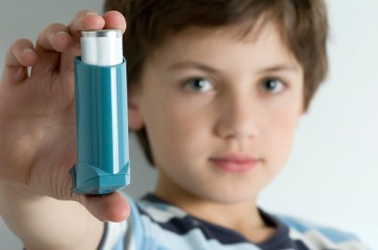 Boy holding ventolin inhaler