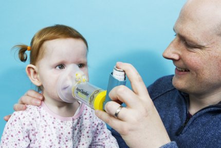 Child using a Spacer to take asthma medication